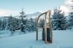 brown wooden snow sled on snow covered ground during daytime