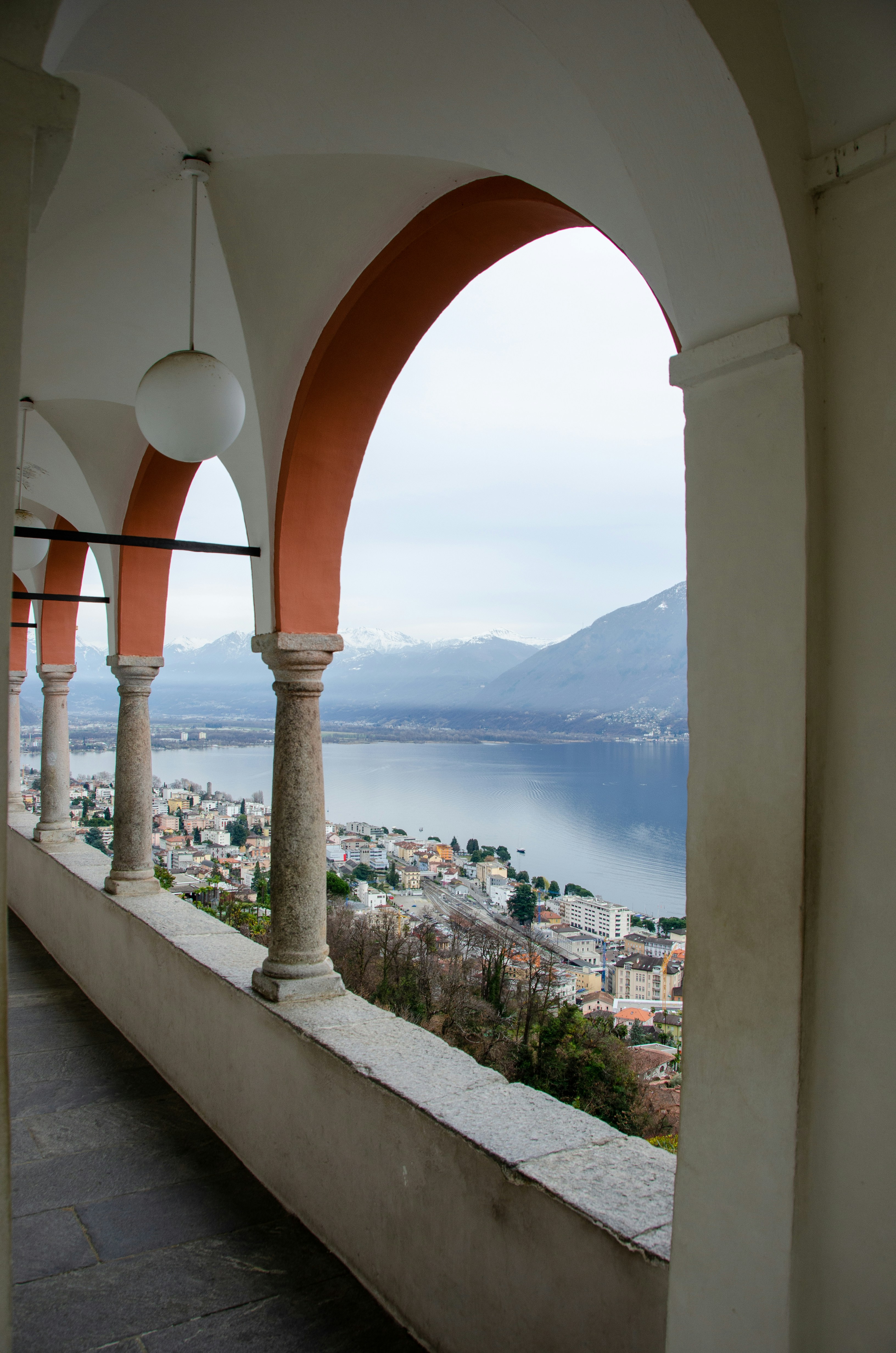 white concrete arch near body of water during daytime