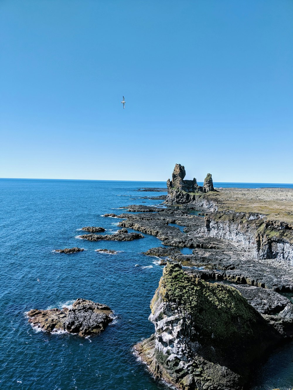 gray rock formation on sea during daytime