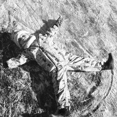 The kids bundled up in bright ski gear, making snow angels on a fresh blanket of powder.