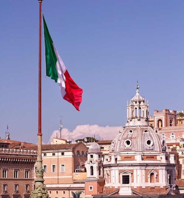 white concrete building with flag of us a during daytime