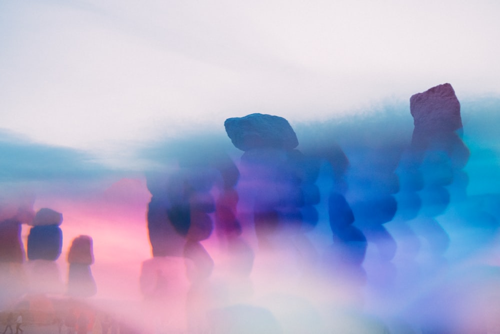 silhouette of 3 person standing on rock formation