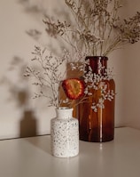 red flowers in white ceramic vase