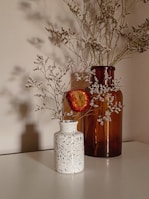 red flowers in white ceramic vase