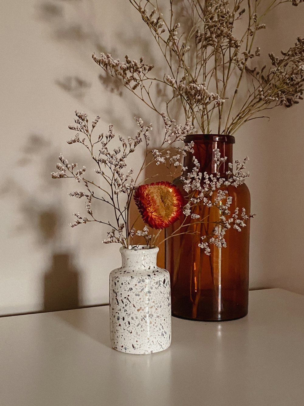 red flowers in white ceramic vase