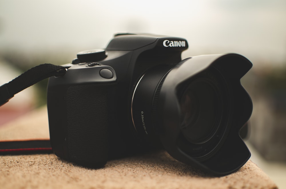 black nikon dslr camera on brown textile