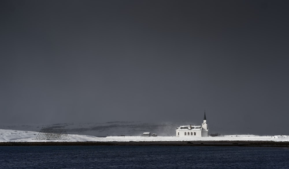 white ship on sea under gray sky
