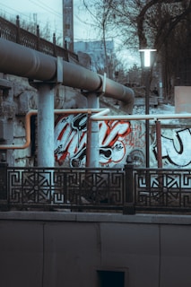 coca cola signage on black metal fence
