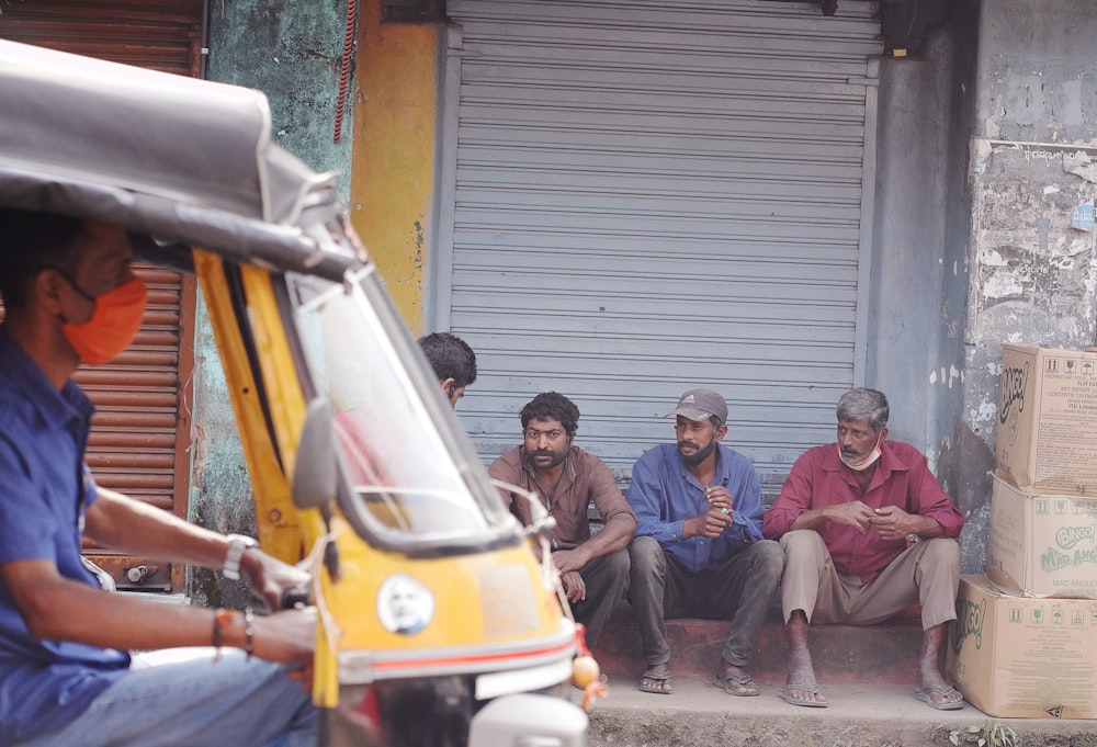 group of people sitting on the street during daytime