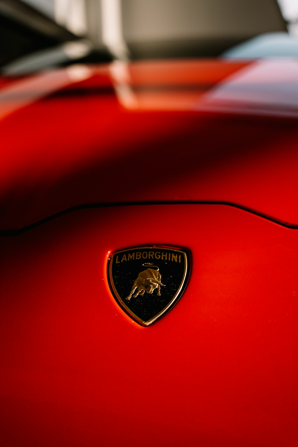 a close up of the emblem on a red sports car