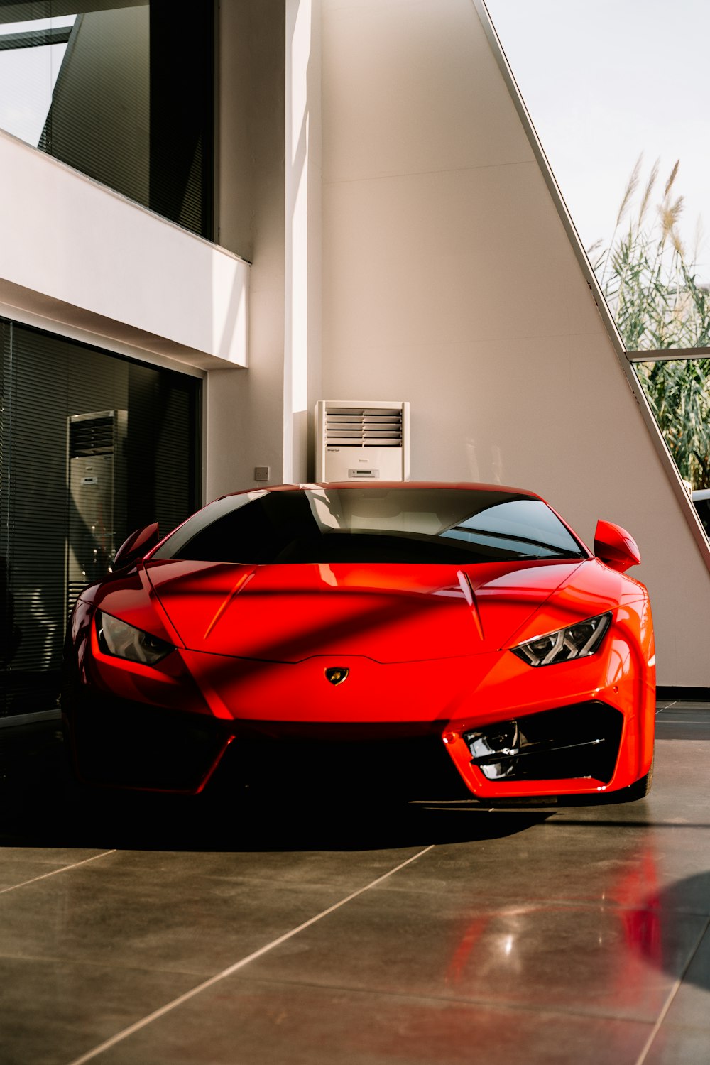 red ferrari 458 italia parked near white building