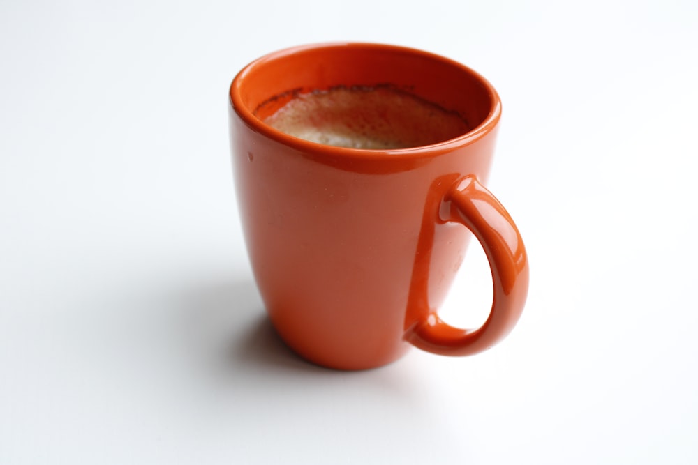 brown ceramic mug with brown liquid