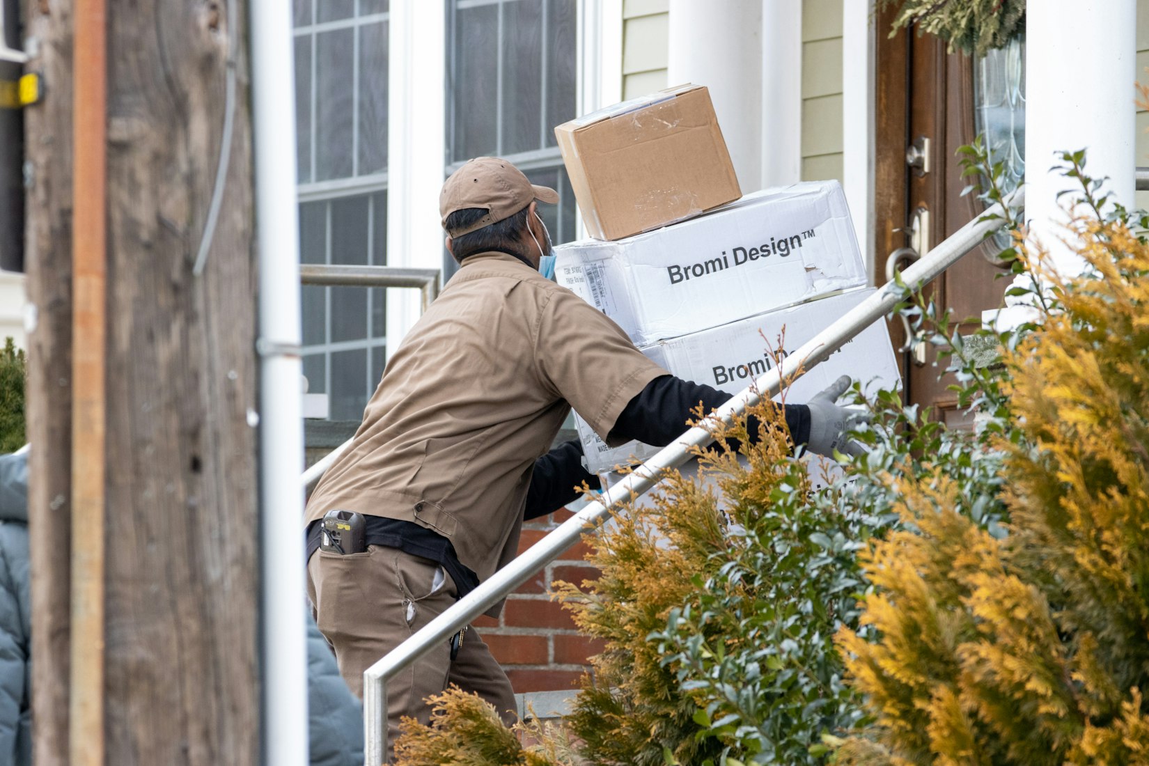 A UPS worker delivering packages (Aaron Doucett via Unsplash)