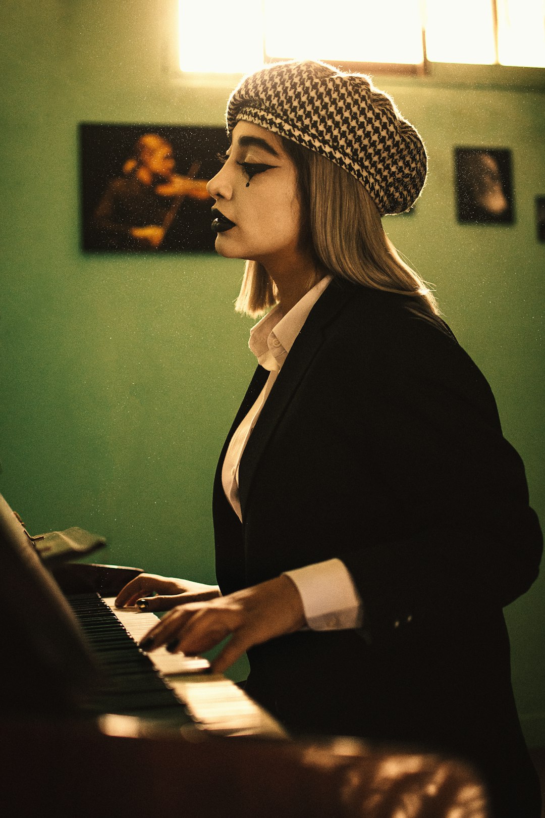 woman in black blazer playing piano