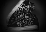 A pair of white sneakers with unique, eye-catching printed patterns.
