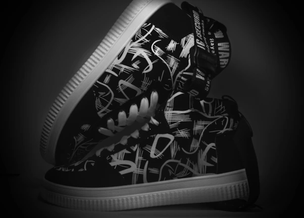 A pair of white sneakers with unique, eye-catching printed patterns.