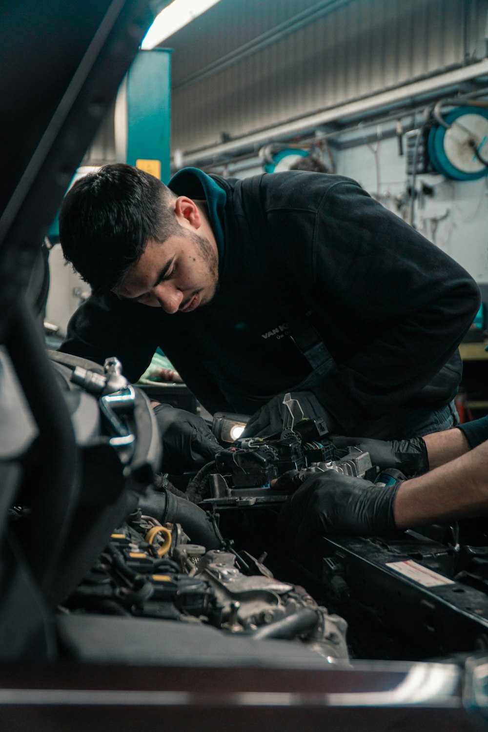 Repairman Auto Mechanic Caucasian White Man With Tattoos On Hands Working  In A Car Repair Shop Fixing The Electrical Wires Nearby The Engine Under  The Hood High-Res Stock Photo - Getty Images