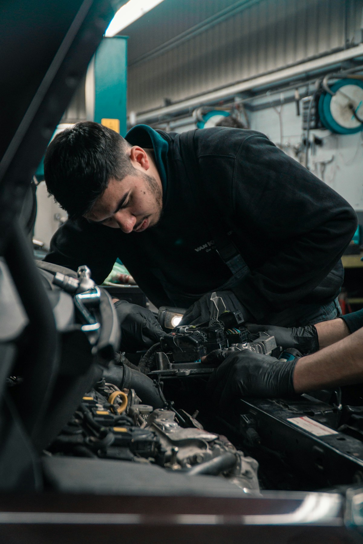 Technician installing a GReddy Type RS BOV in the engine bay