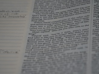 Close-up of hands annotating a research paper with notes and citations.
