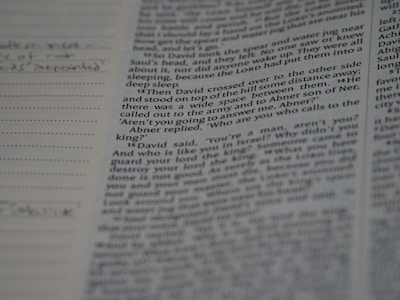 A close-up of an open book with handwritten notes in the margins, capturing the intimate process of writing.