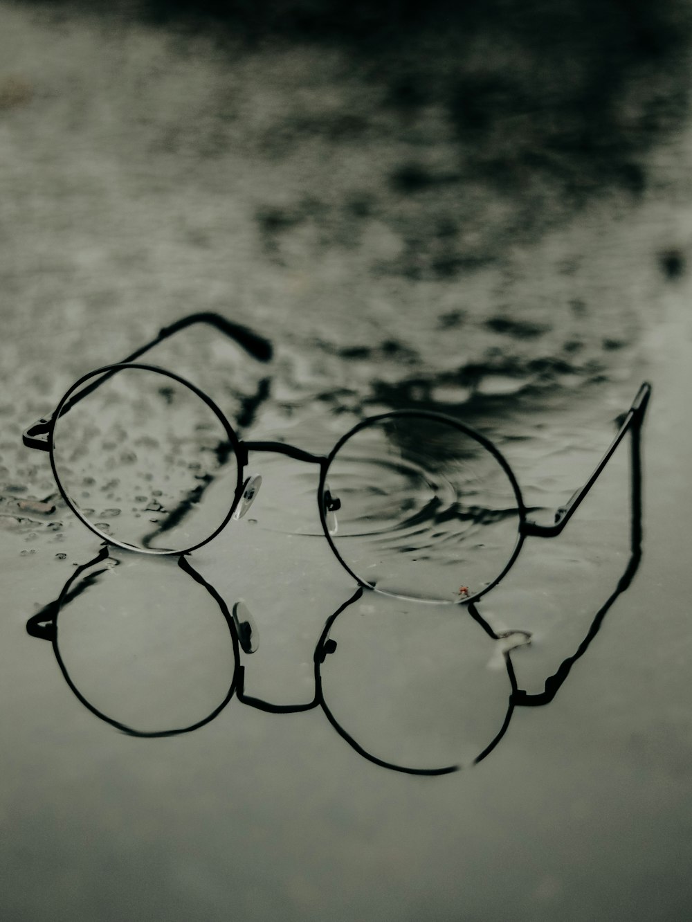 silver framed eyeglasses on white surface