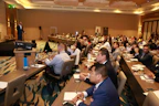 A vibrant conference hall filled with engaged attendees networking during a break.