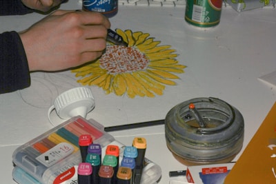 person holding blue and yellow hair brush