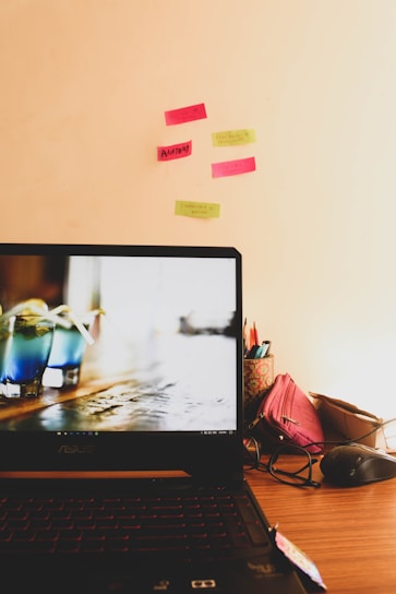A cozy workspace with a laptop displaying the blinxos online store homepage surrounded by trendy products.