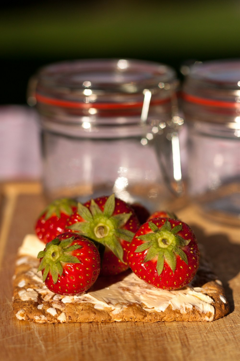 strawberries in clear glass jar