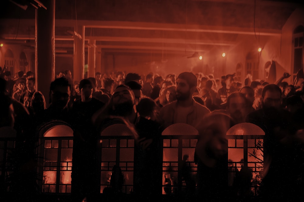 people standing on stage with red lights