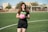 woman in black and pink nike soccer jersey shirt and black shorts holding pink ball