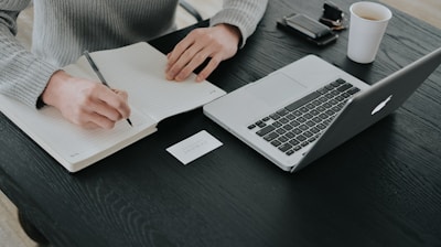 person in white dress shirt holding white paper