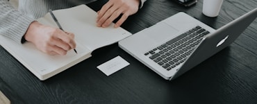 person in white dress shirt holding white paper