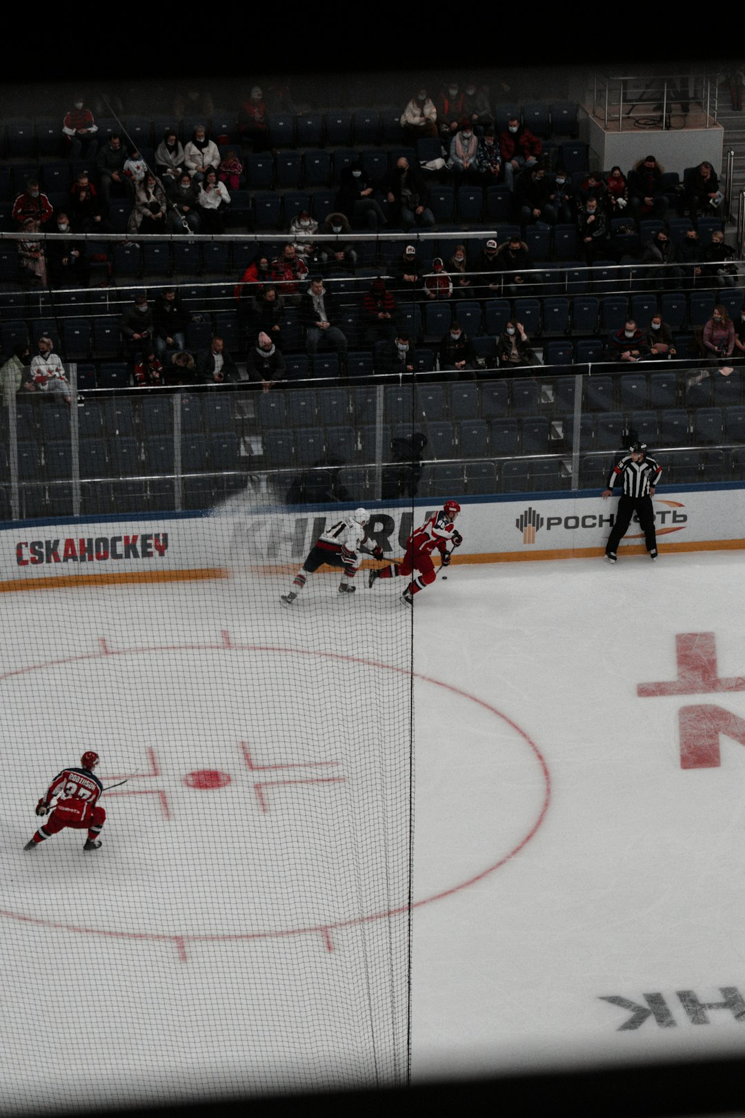 people playing ice hockey on ice stadium