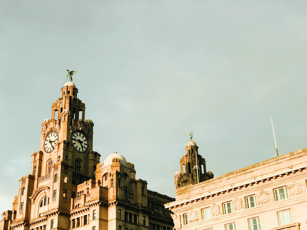 brown concrete building (liver building) under grey sky during daytime, demonstrating colonialism 
