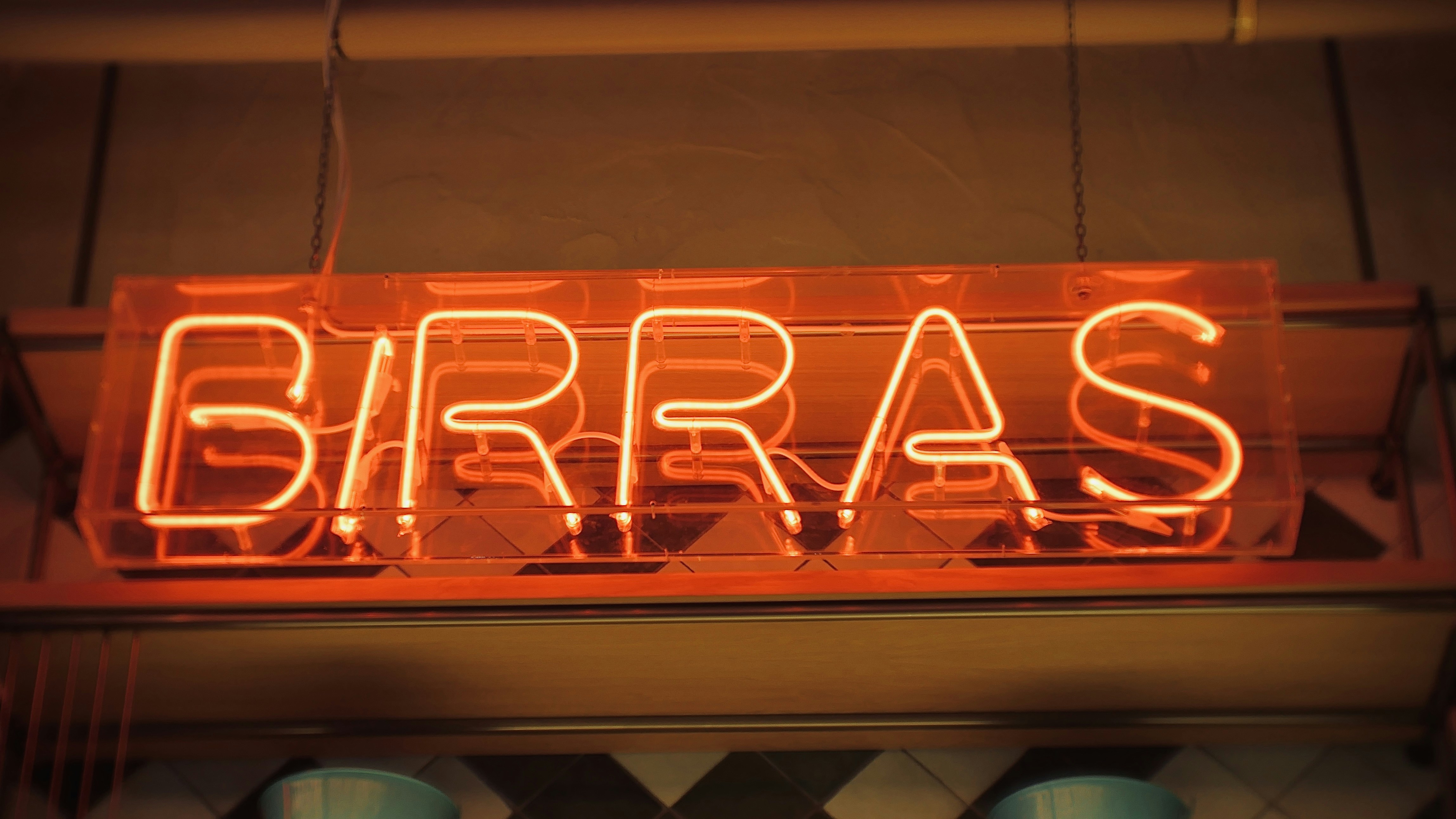 a neon sign hanging from the side of a building