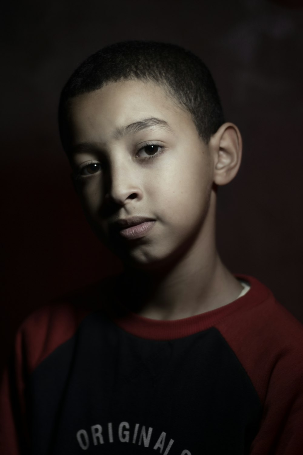 boy in red and black crew neck shirt