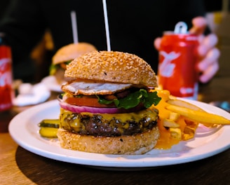 burger with lettuce and tomato on white ceramic plate