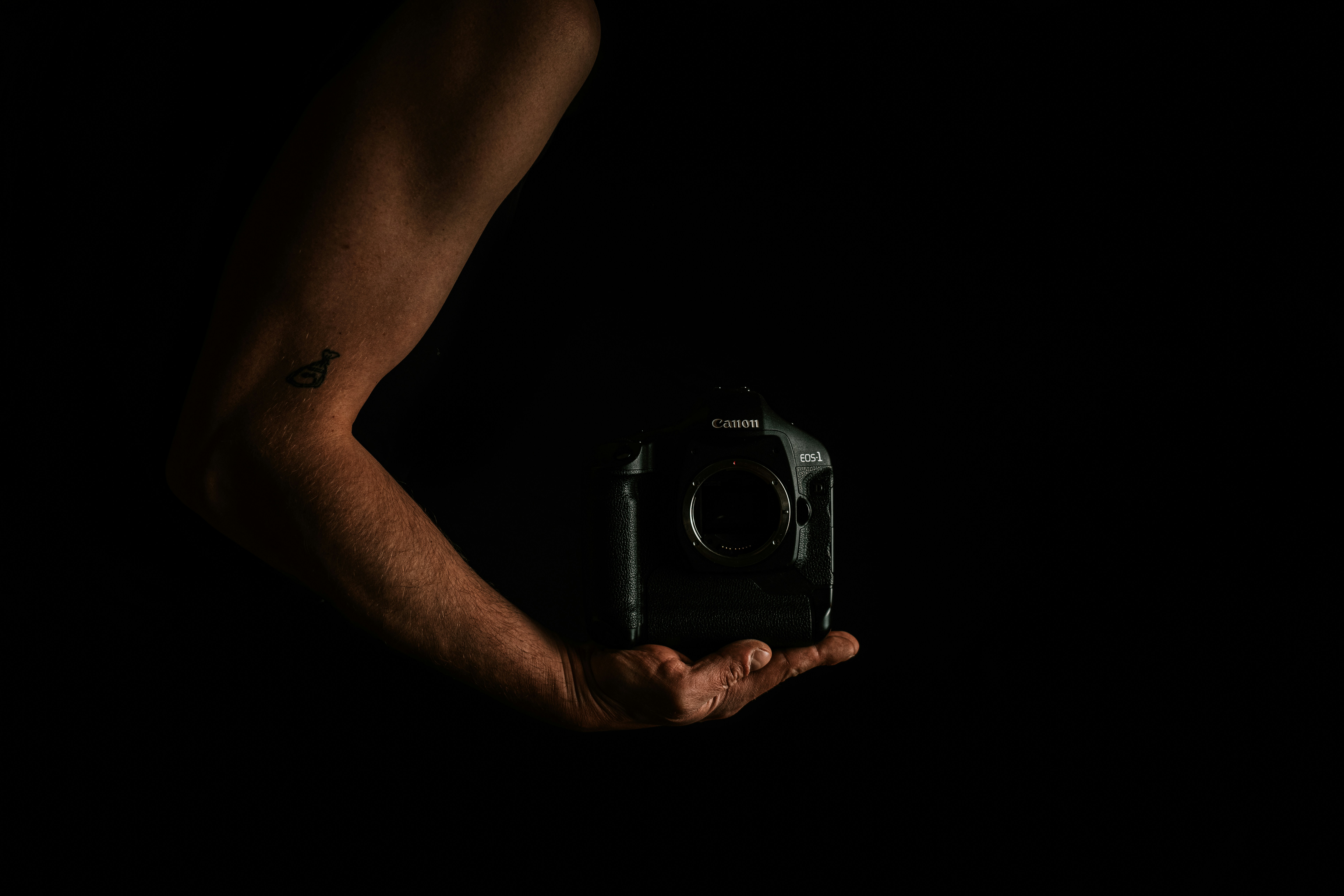 person holding black and silver camera