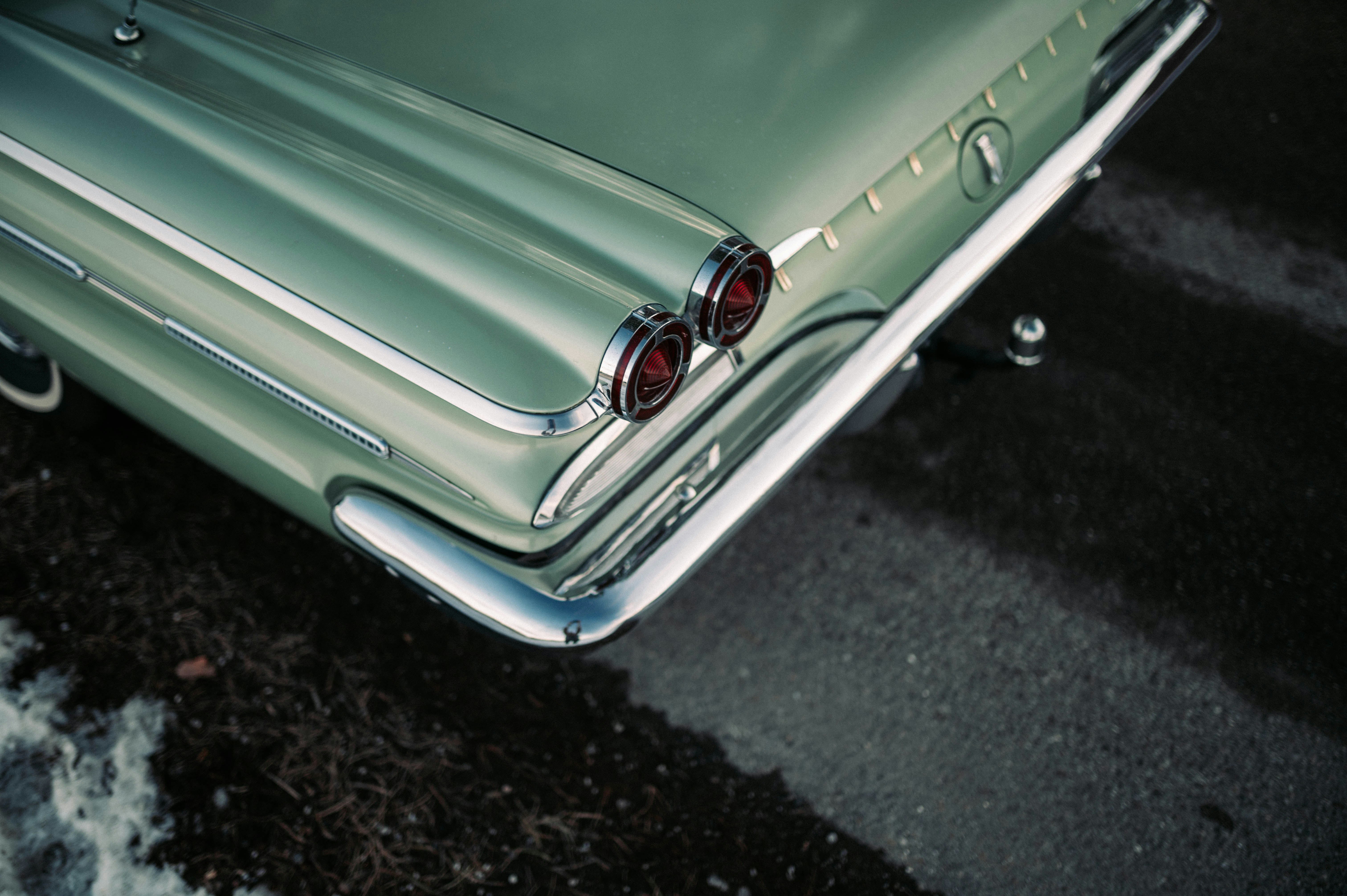 green car on black asphalt road