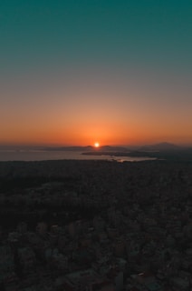 A scenic sunset over a landmark cityscape with glowing lights.