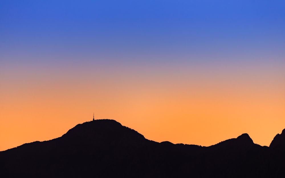 silhouette of mountain during sunset