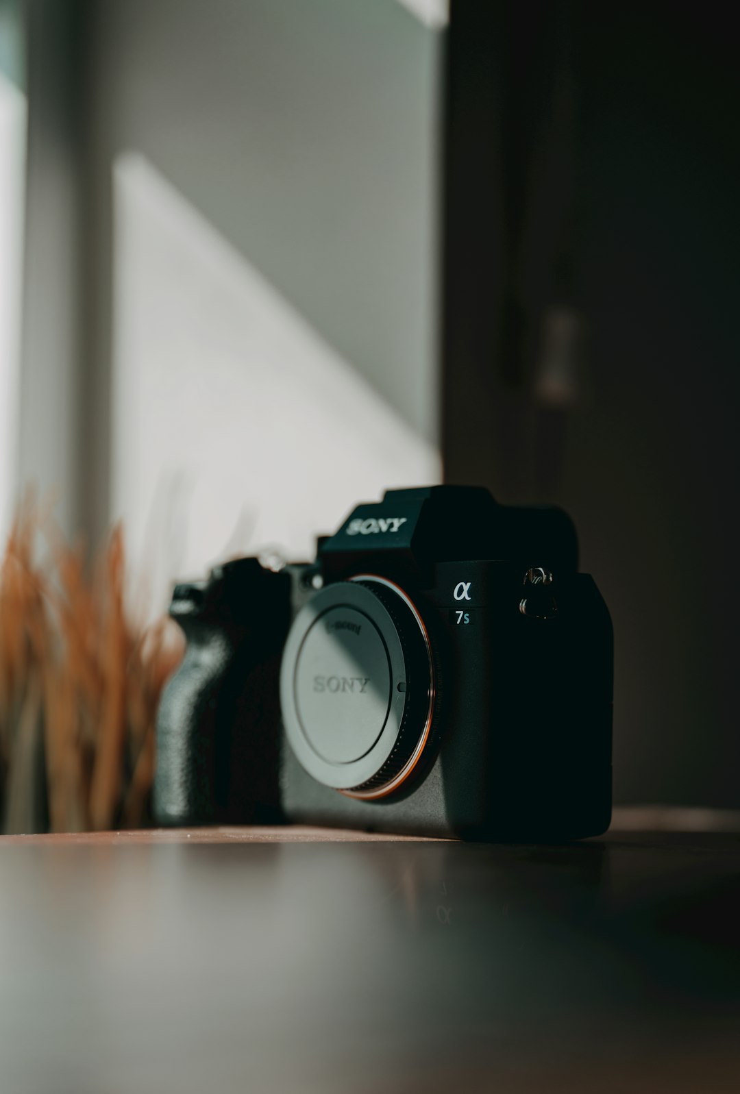 black nikon dslr camera on brown wooden table