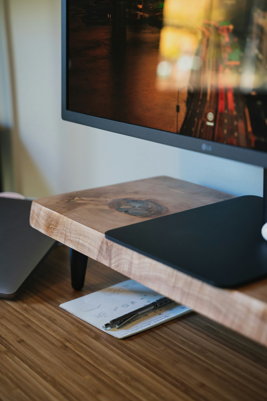 black laptop computer on brown wooden table