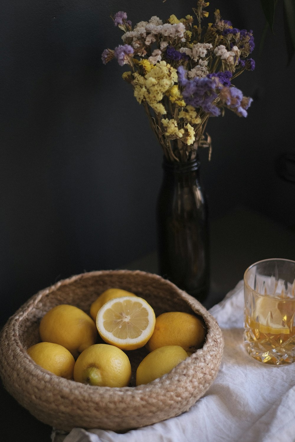 yellow flowers in clear glass vase