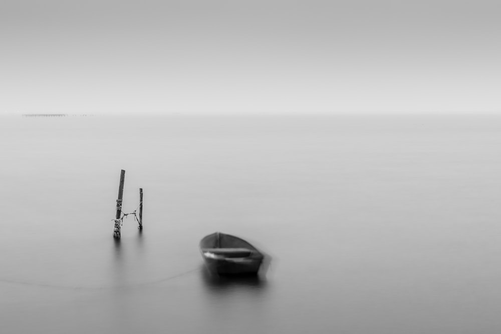 grayscale photo of boat on body of water