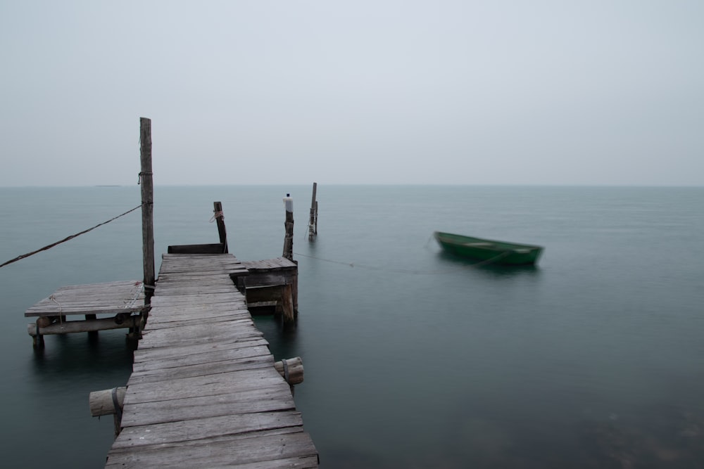 brown wooden dock on body of water during daytime