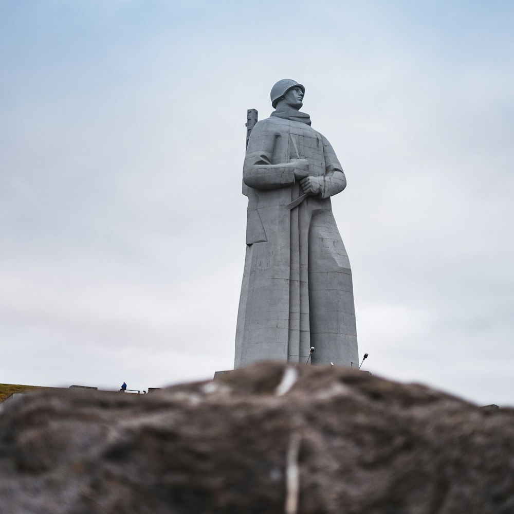 gray concrete statue under gray cloudy sky