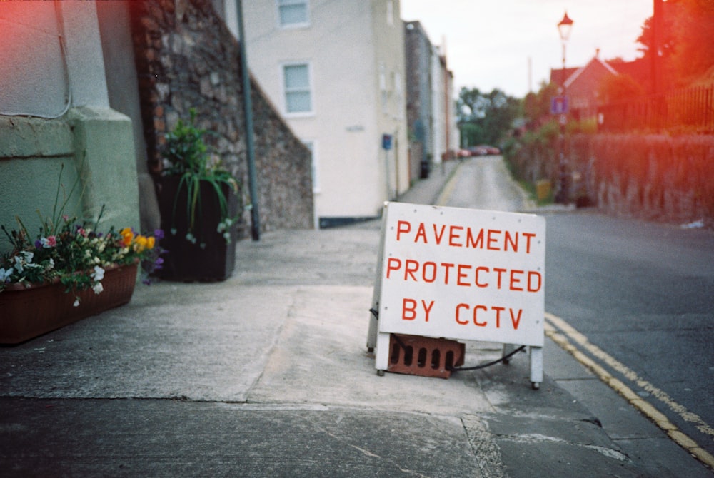 white and red signage on gray concrete floor