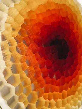 Close-up of a vibrant geometric tile pattern in warm earth tones.